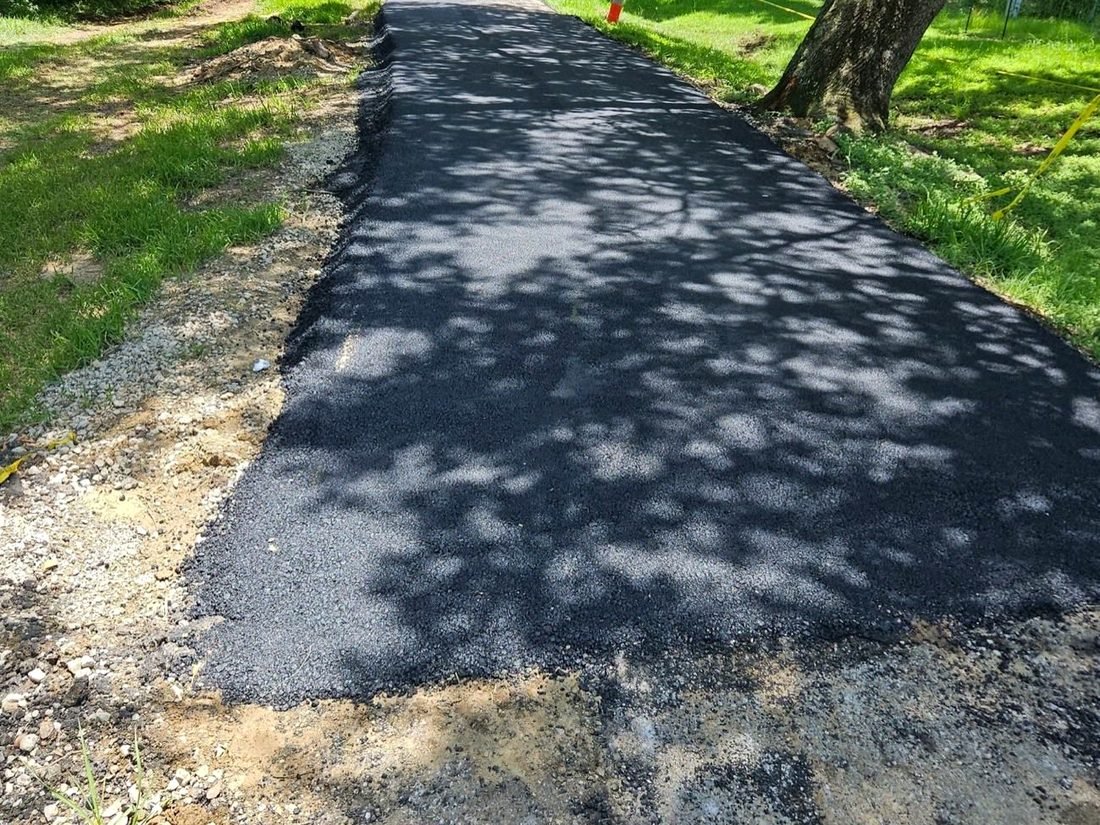 New residential asphalt through a wooded lot